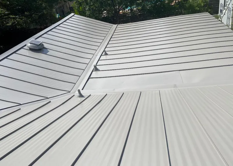 Solar attic fan installed on a metal roof for Roof Ventilation in Hermon
